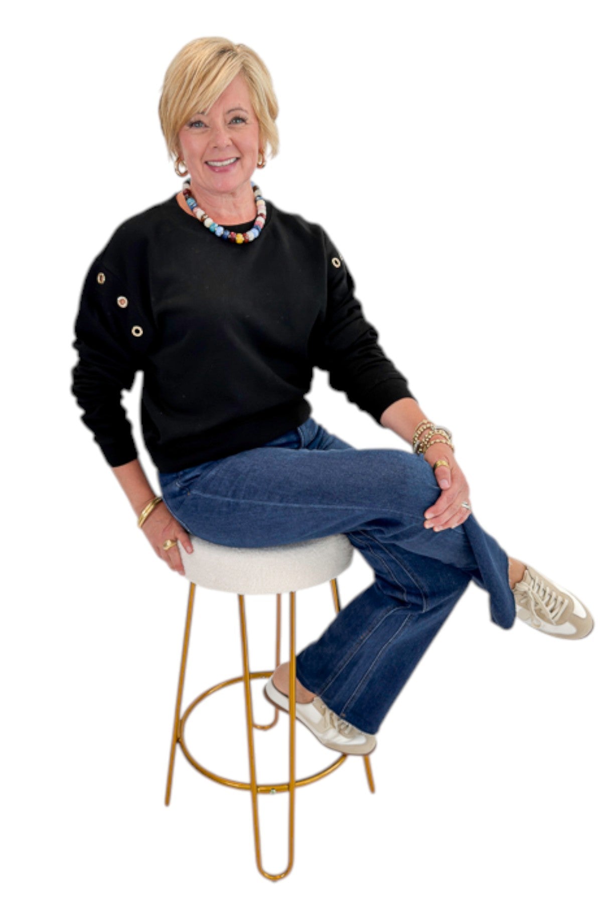 Front view of woman wearing Swagger Boutique’s Black Axel Grommet Sweatshirt by Z Supply with jeans against white studio background.