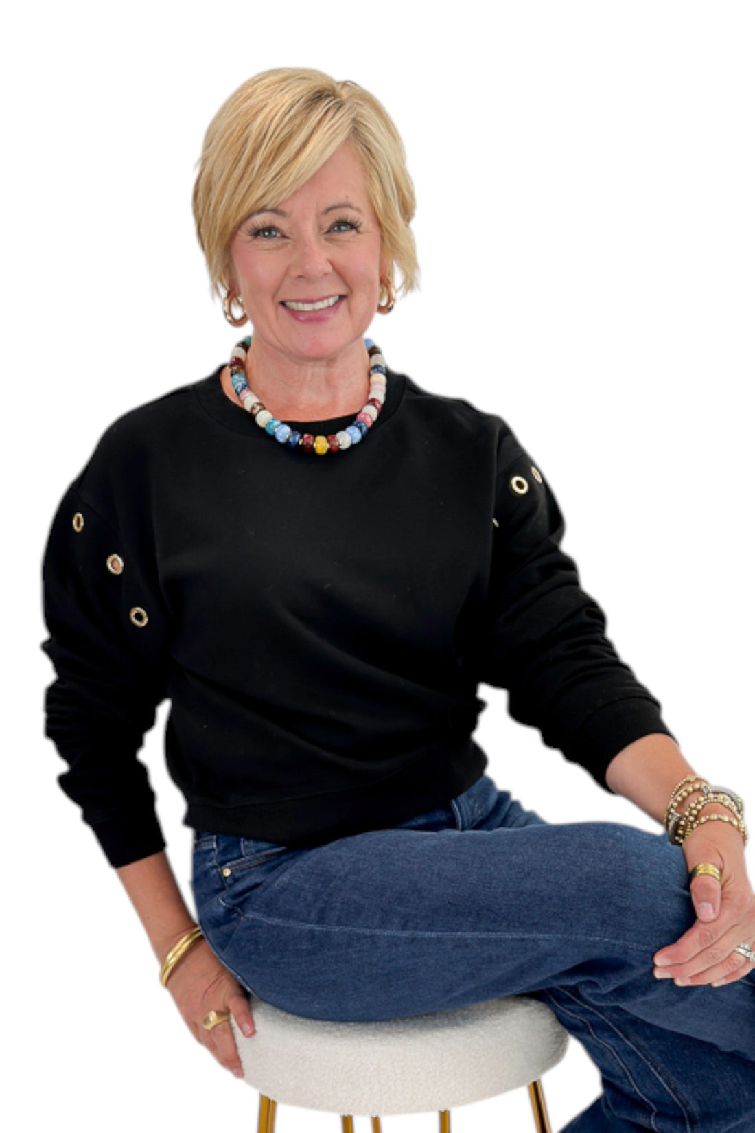 Front view of woman wearing Swagger Boutique’s Black Axel Grommet Sweatshirt by Z Supply with jeans against white studio background.