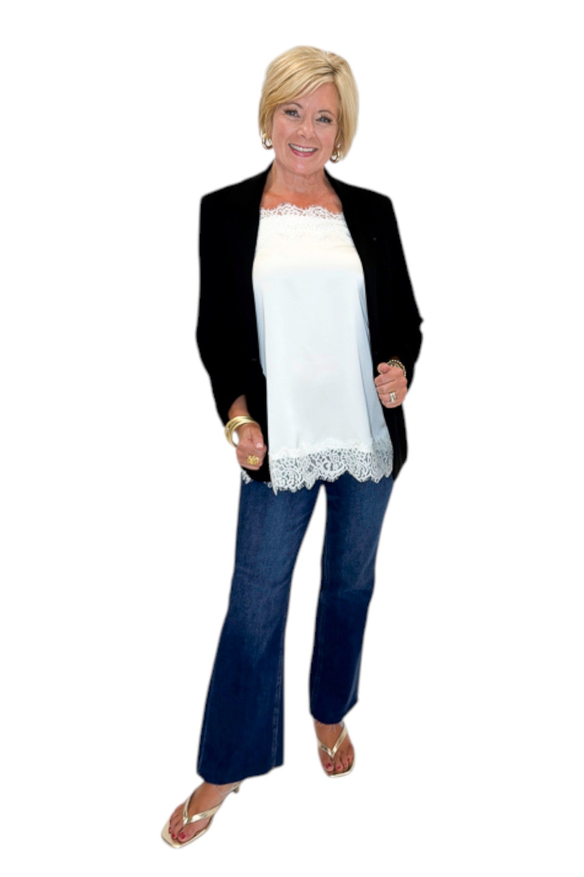 Front view of woman wearing Swagger Boutique’s Black Blazer and Ivory Satin Lace Trim Tank Top by Entro with jeans against white studio background.
