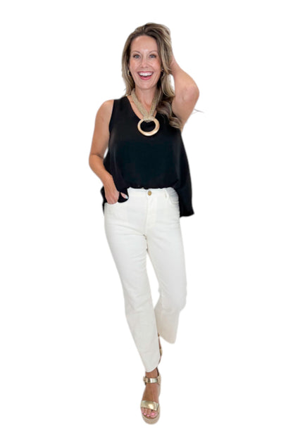 Front view of woman wearing Swagger Boutique’s Black Bubble Hem Tank with jeans against white studio background.
