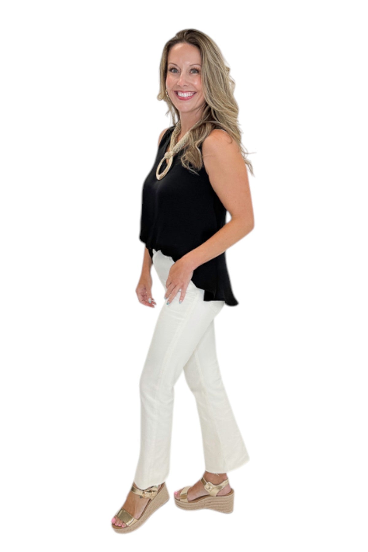 Side view of woman wearing Swagger Boutique’s Black Bubble Hem Tank with jeans against white studio background.
