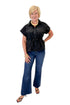 Front view of woman wearing Swagger Boutique’s Black Cinched Waist Short Sleeve Top by Entro with jeans against white studio background.