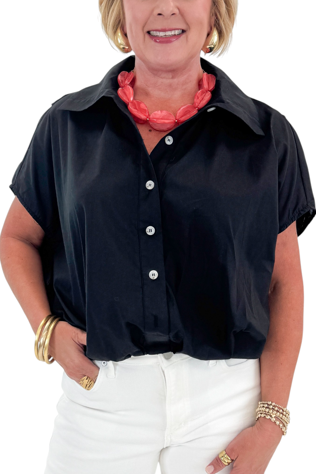 Front detail view of woman wearing Swagger Boutique’s Black Collared Bubble Hem Top with jeans against white studio background.