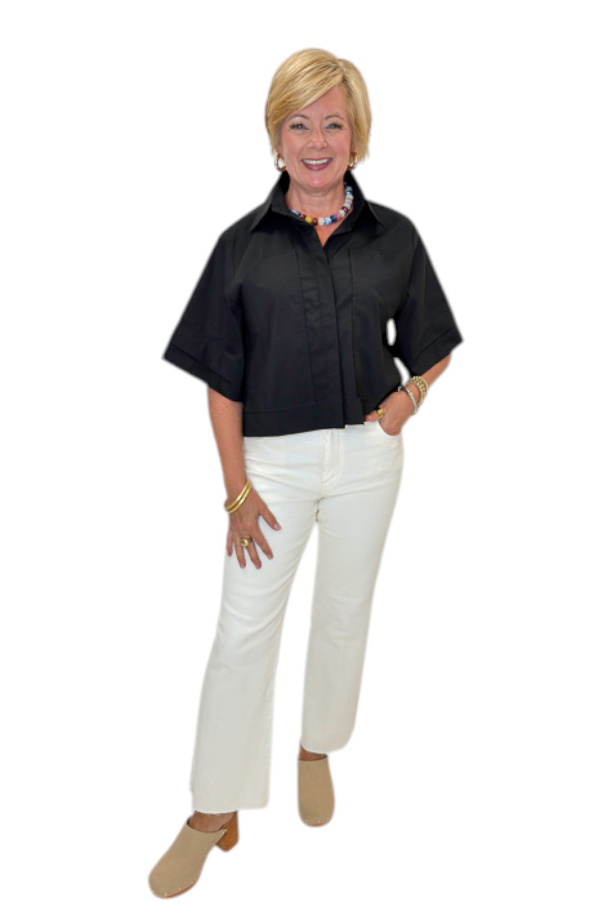 Front view of woman wearing Swagger Boutique’s Black Collared Short Sleeve Top with jeans against white studio background.