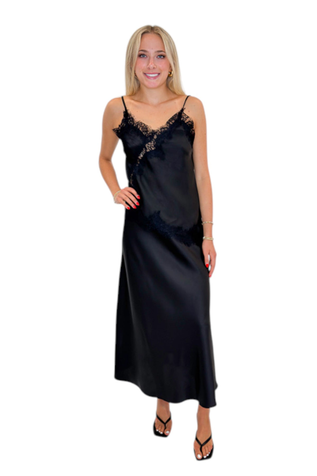 Front view of woman wearing Swagger Boutique’s Black Satin Lace Tank with Black Flare Satin Midi Skirt against white studio background.