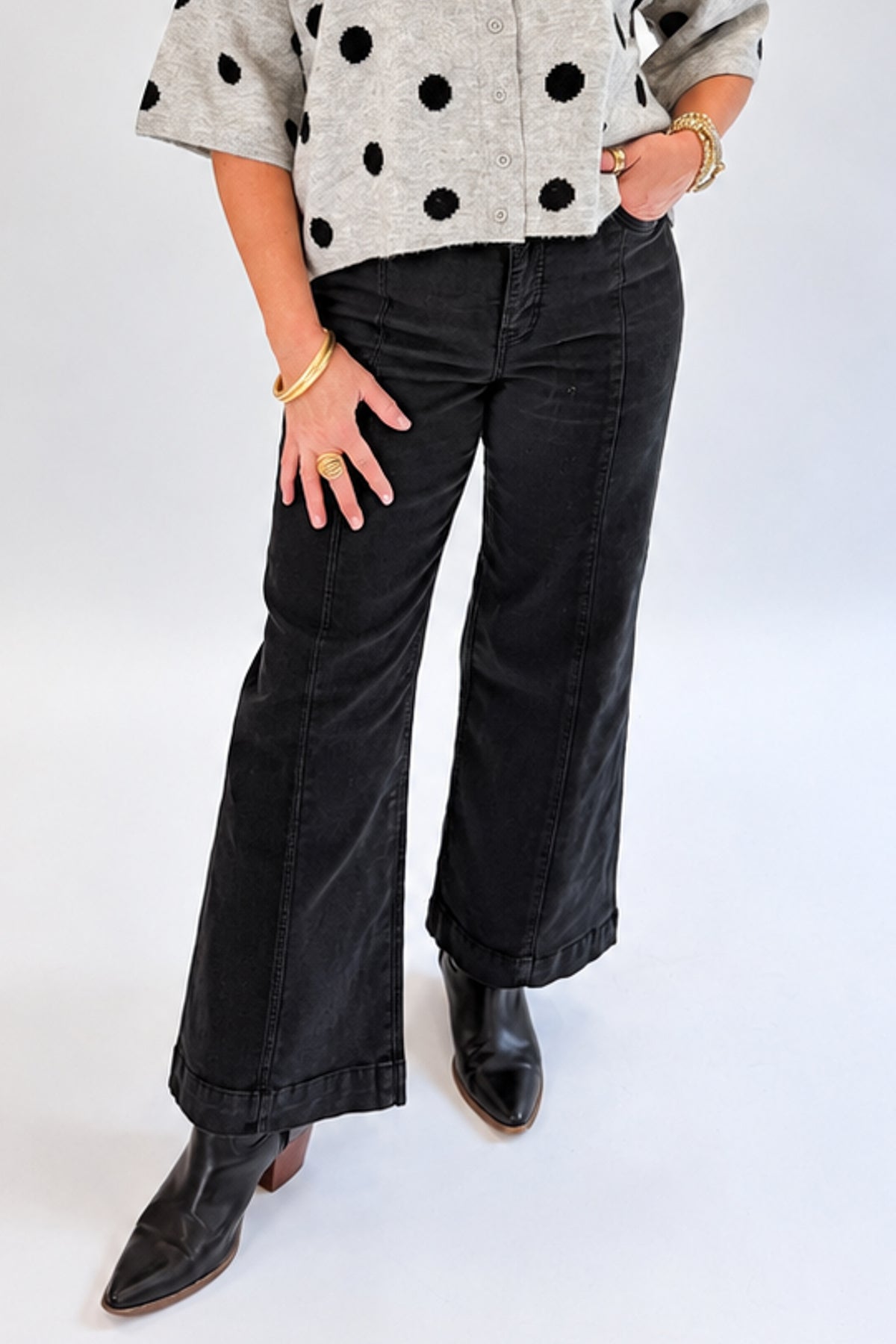 Front view of woman wearing Swagger Boutique’s Black Pintuck Jeans by Risen with sweater against white studio background.