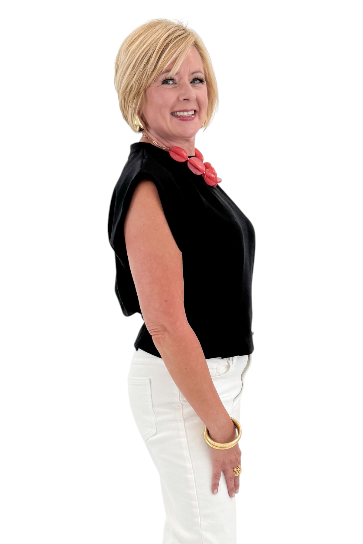Side view of woman wearing Swagger Boutique’s Black Pleat Detail Tank with jeans against white studio background.