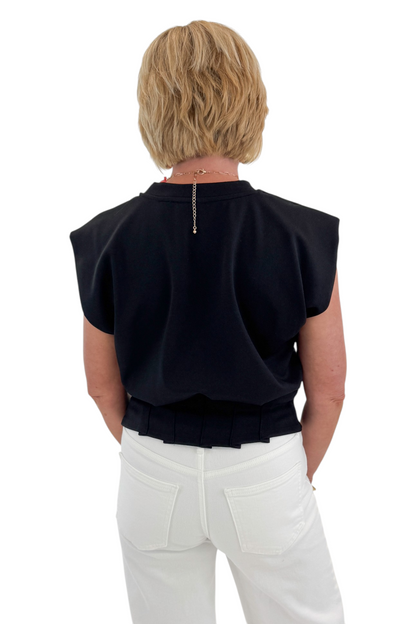 Back view of woman wearing Swagger Boutique’s Black Pleat Detail Tank with jeans against white studio background.