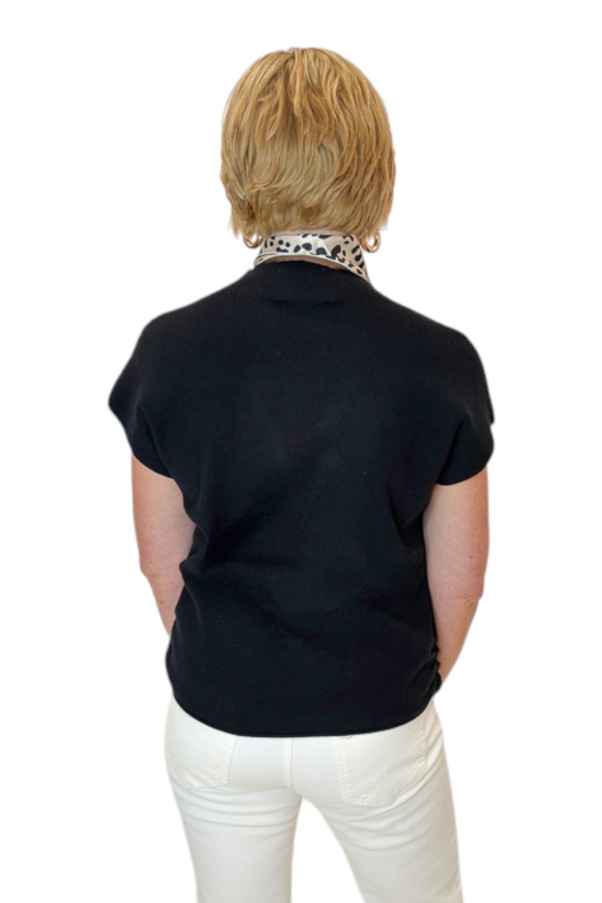 Back view of woman wearing Swagger Boutique’s Black Shirred Cap Sleeve Sweater with jeans against white studio background.