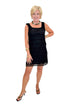 Front view of woman wearing Swagger Boutique’s Black Sleeveless Lace Mini Dress by Entro with heels against white studio background.