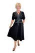 Front view of woman wearing Swagger Boutique’s Black Stitch Midi Dress with heels against white studio background.