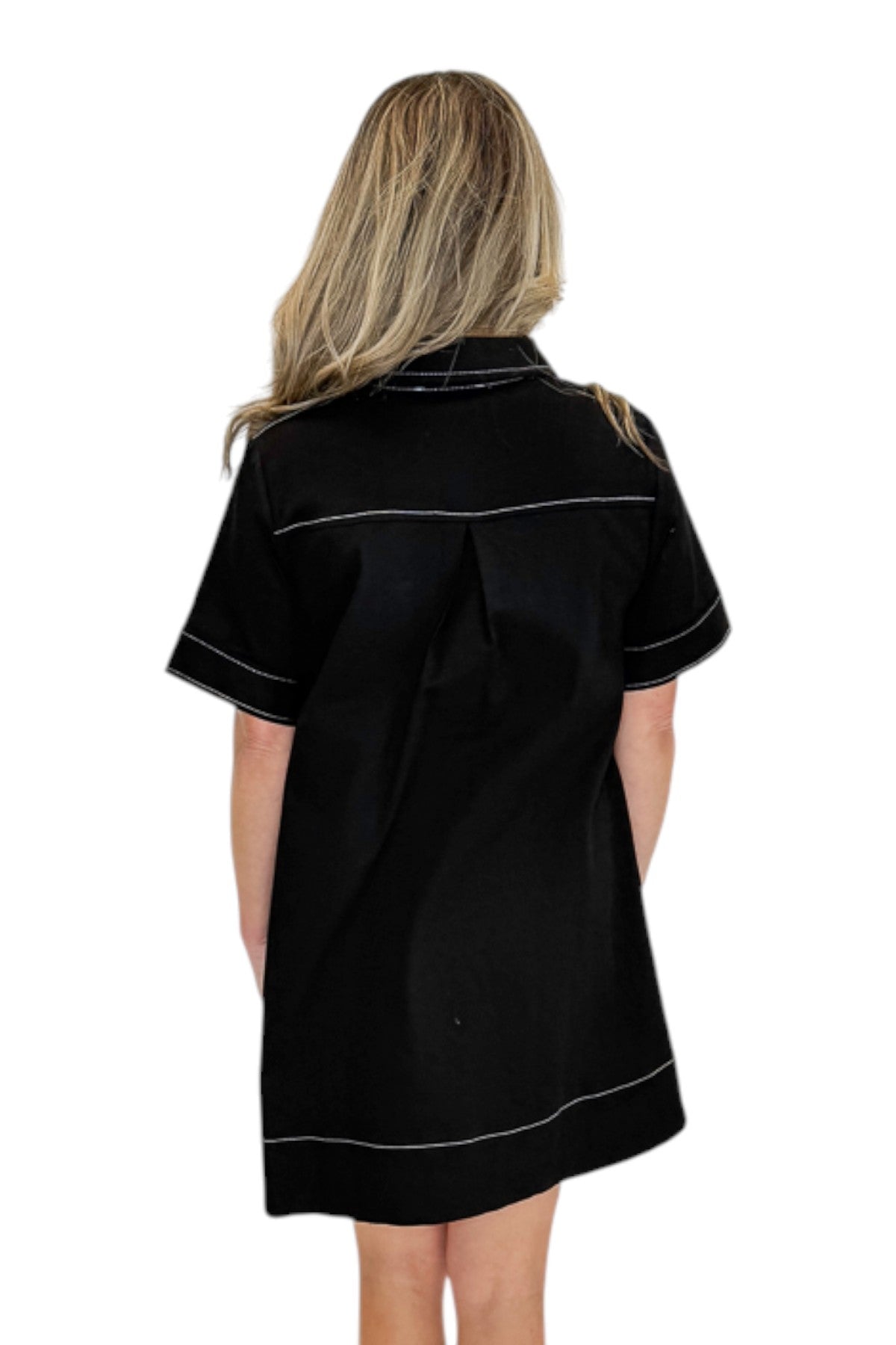 Back view of woman wearing Swagger Boutique’s Black Stitched Mini Dress against a white studio background. 