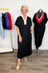 Front view of woman wearing Swagger Boutique’s Black With Cream Lining Midi Dress with sandals with clothing hanging in the background. 