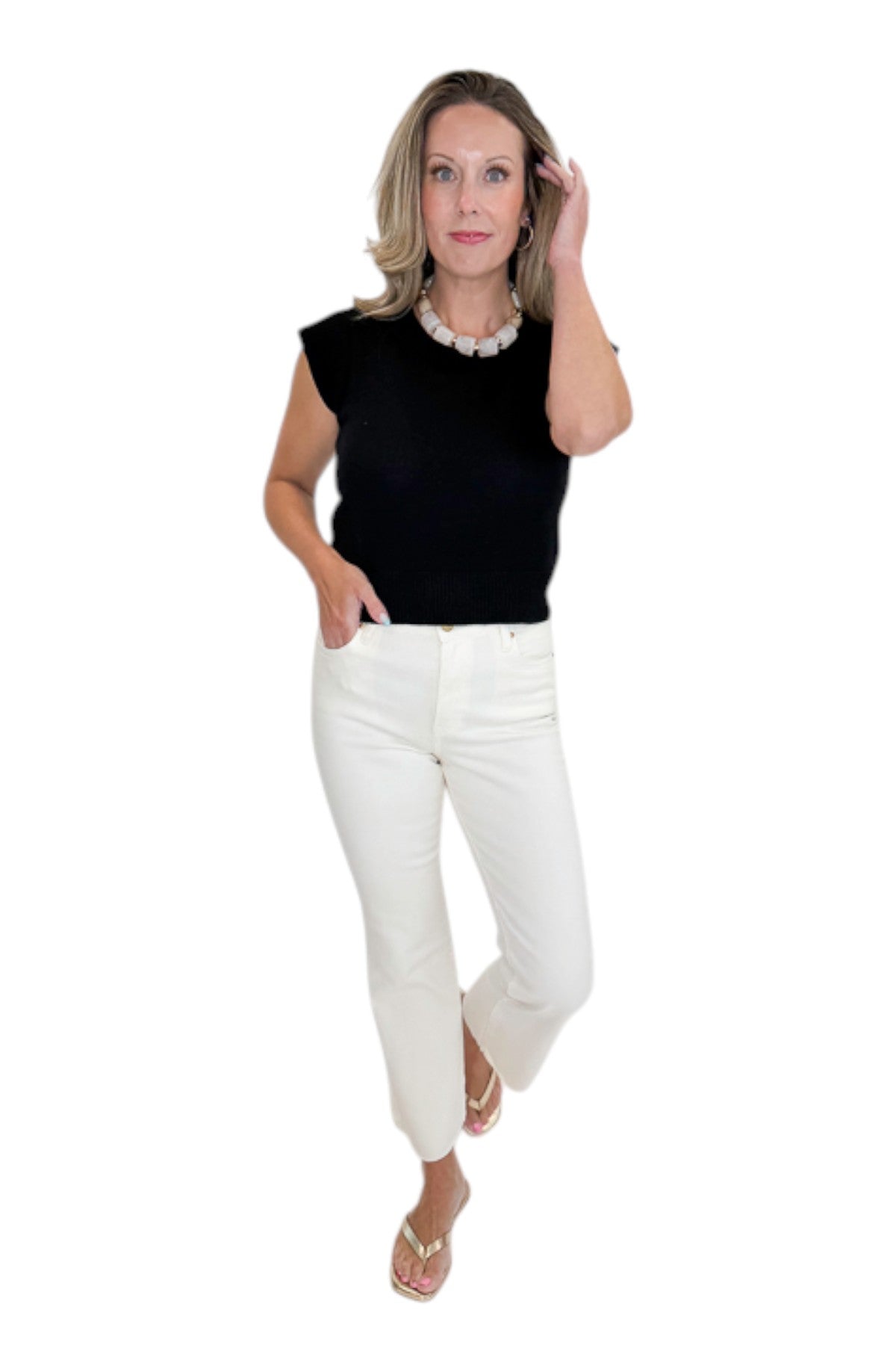 Front view of woman wearing Swagger Boutique’s Black Cap Sleeve Sweater with jeans against white studio background.