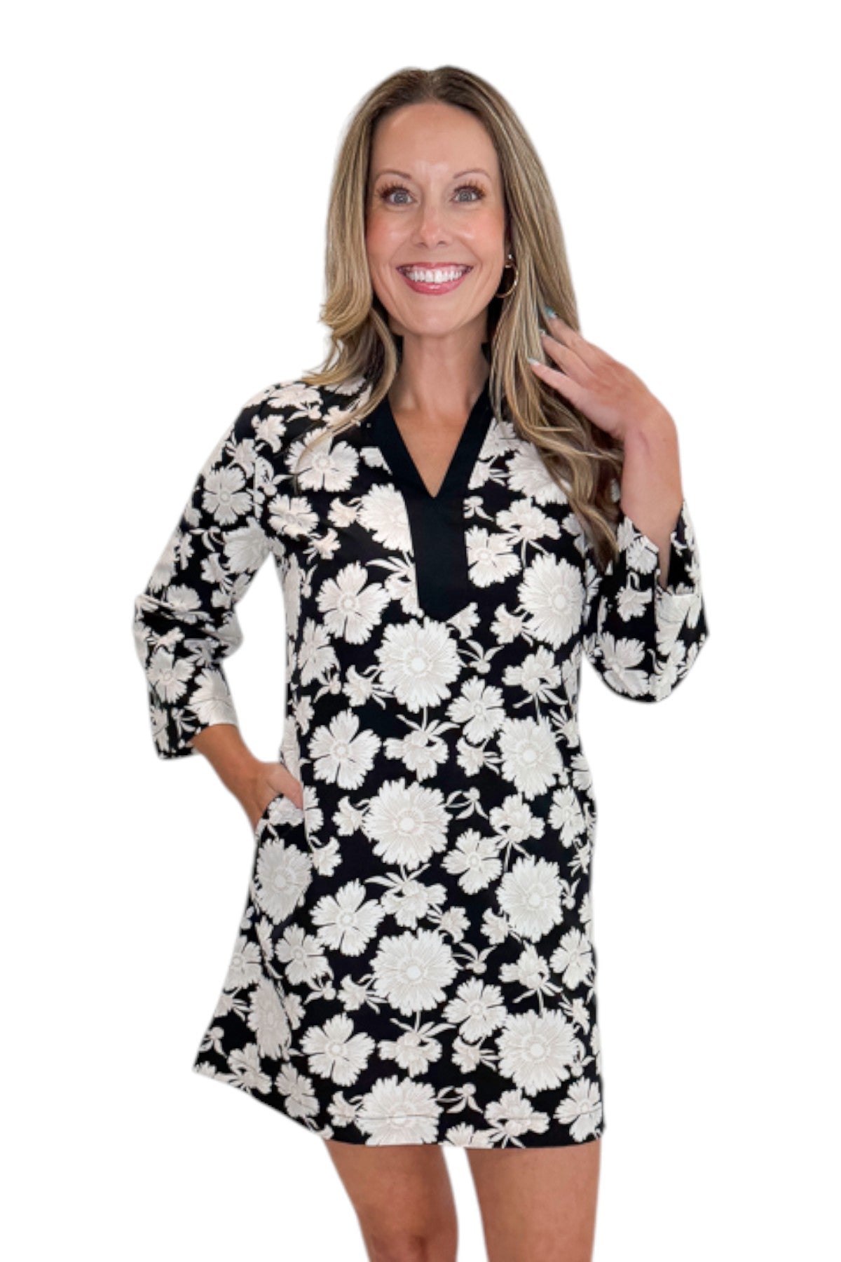 Front view of woman wearing Swagger Boutique’s Black &amp; Cream Floral Shift Dress with sandals against white studio background.