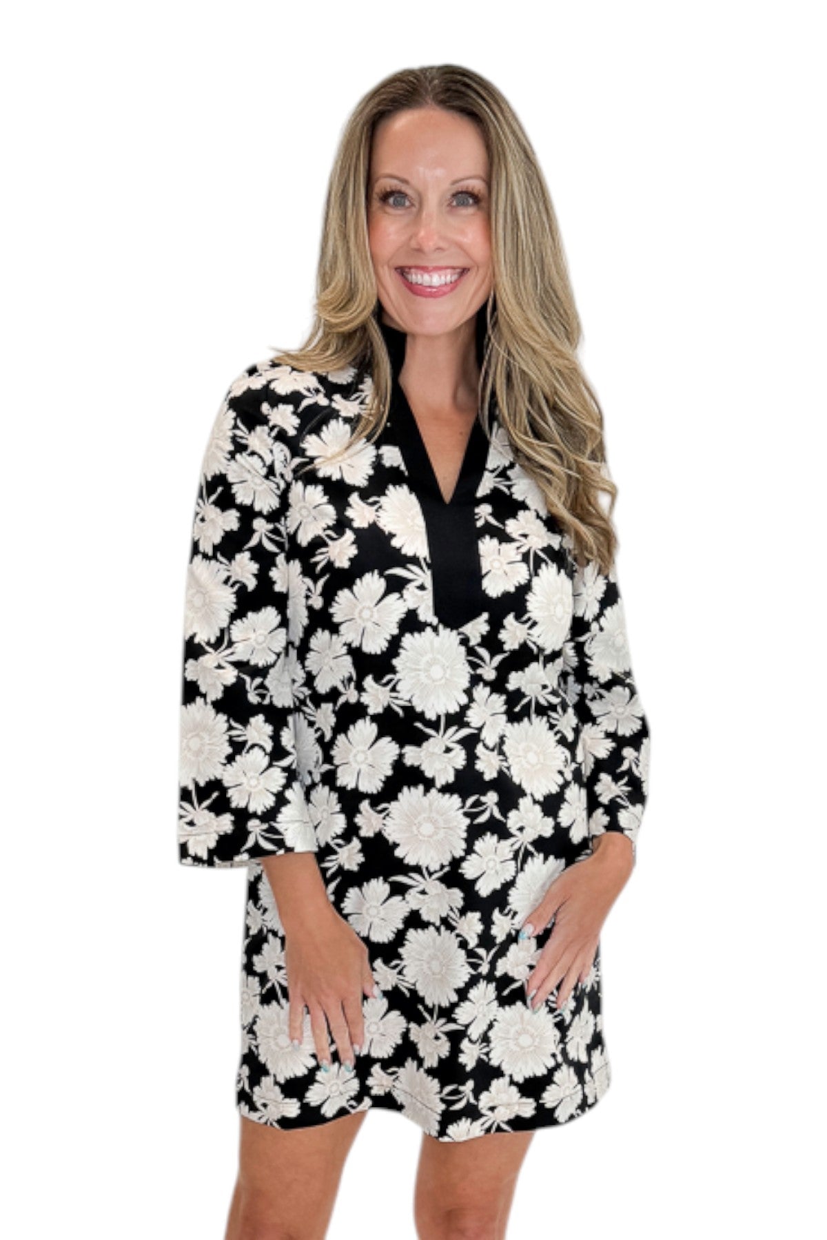 Front view of woman wearing Swagger Boutique’s Black &amp; Cream Floral Shift Dress with sandals against white studio background.