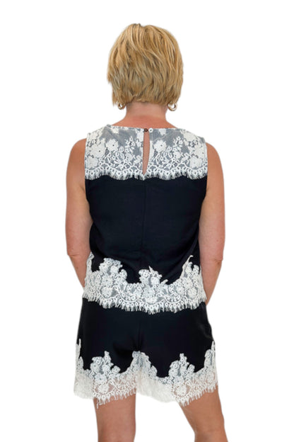 Back view of woman wearing Swagger Boutique’s Black &amp; Cream Lace Lined Tank with Black &amp; Cream Lace Lined Shorts by Entro against white studio background.