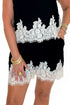 Front detail view of woman wearing Swagger Boutique’s Black & Cream Lace Lined Tank with Black & Cream Lace Lined Shorts by Entro against white studio background.
