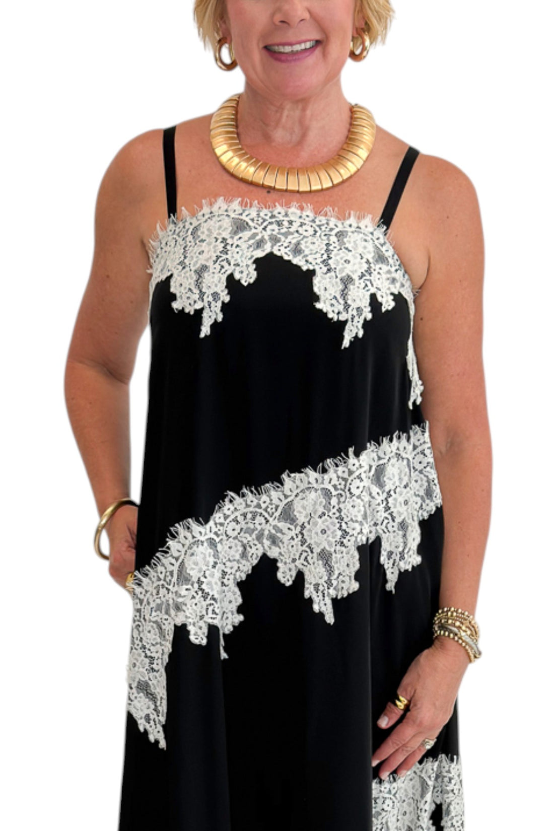 Front detail view of woman wearing Swagger Boutique’s Black &amp; Cream Lace Trim Maxi Dress against white studio background.