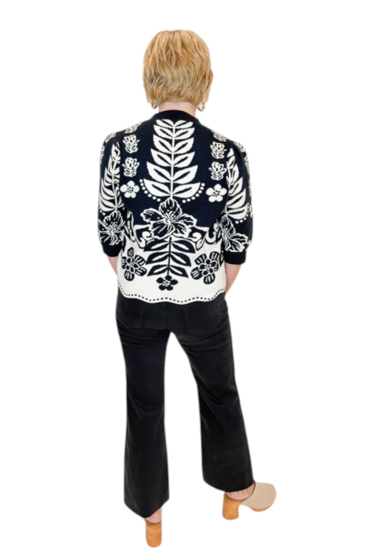 Back view of woman wearing Swagger Boutique’s Black &amp; Cream Printed Short Sleeve Sweater by THML with jeans against white studio background.