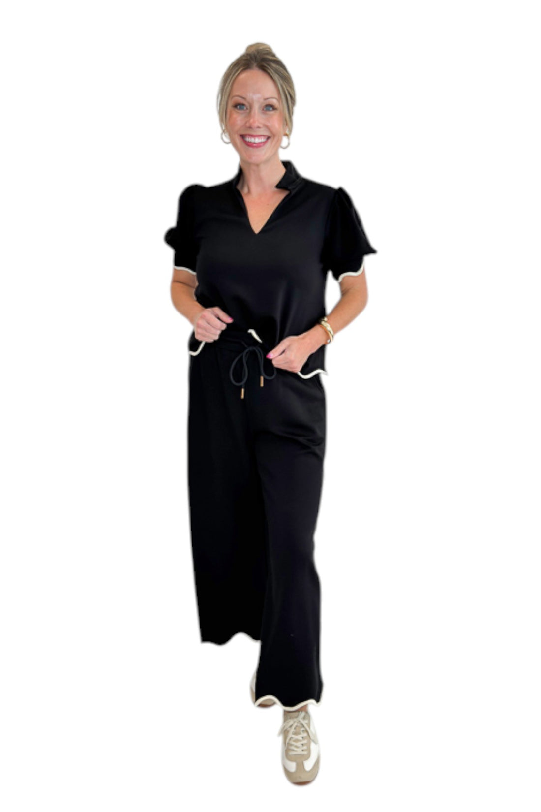 Front view of woman wearing Swagger Boutique’s Black &amp; Cream Scalloped Top by Entro with matching Lounge Pants against white studio background.