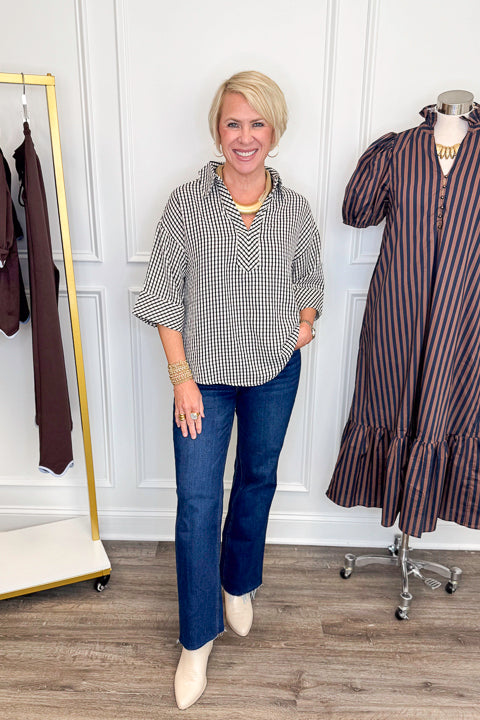 Front view of woman wearing Swagger Boutique’s Black &amp; White Gingham Collared Top by Entro with jeans against white studio background.