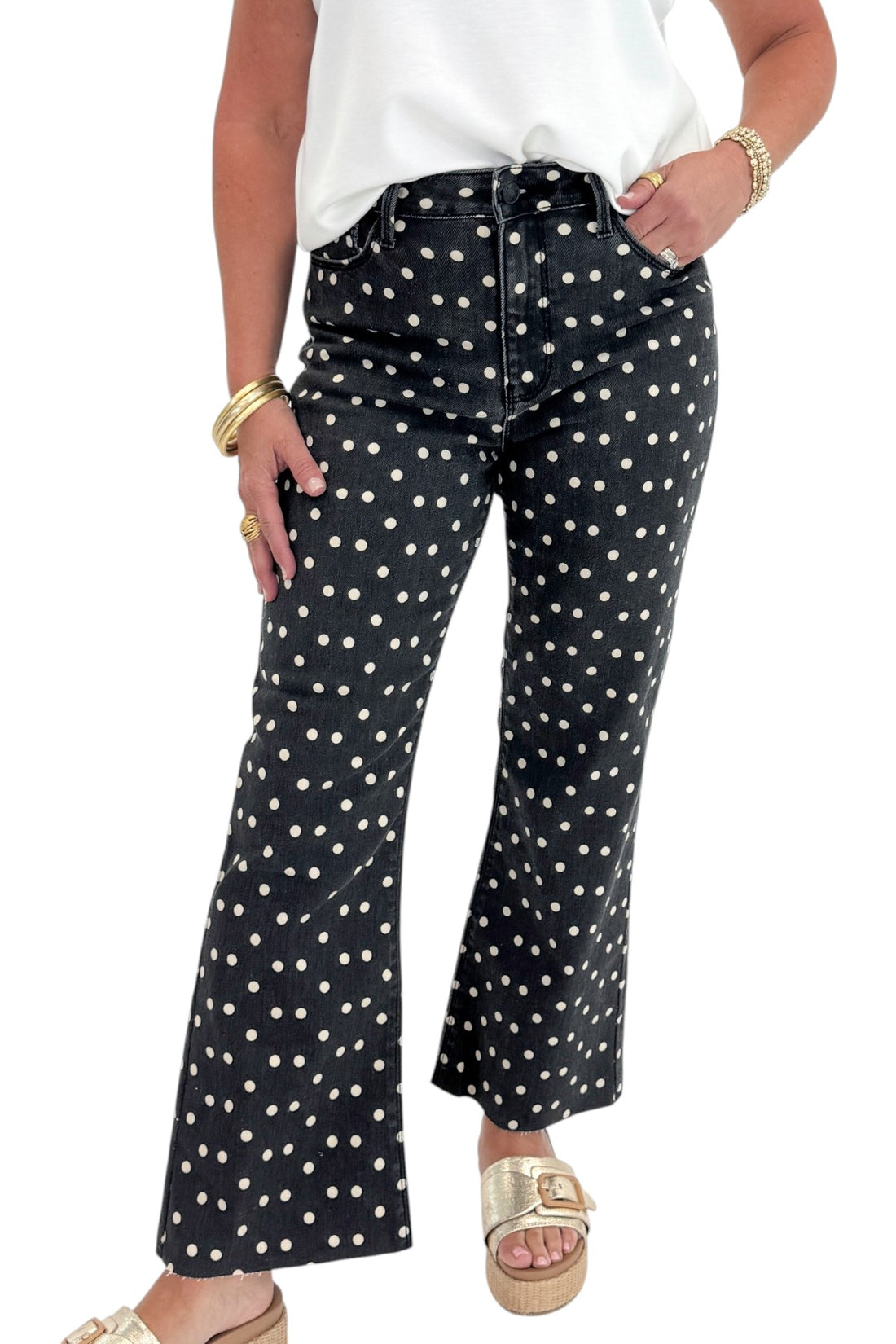 Front view of woman wearing Swagger Boutique’s Black &amp; White Polka Dot Crop Flare Jeans by Just Black Denim with top against white studio background.