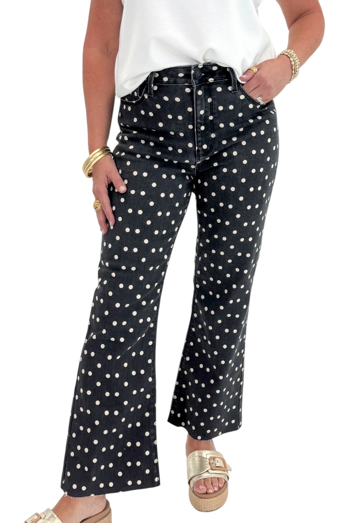 Front view of woman wearing Swagger Boutique’s Black &amp; White Polka Dot Crop Flare Jeans by Just Black Denim with top against white studio background.