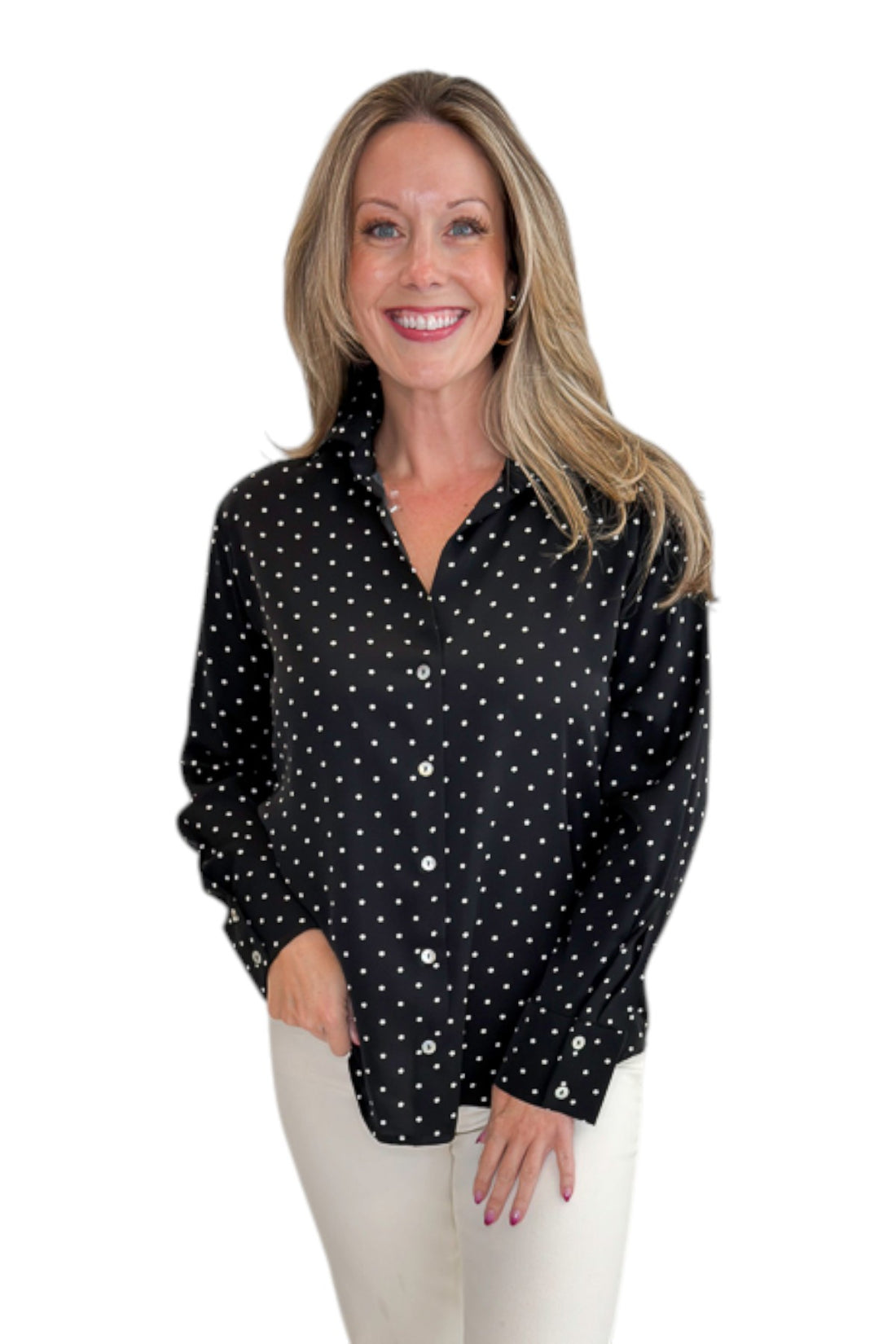 Front view of woman wearing Swagger Boutique’s Black &amp; White Polka Dot Satin Button Up Top with jeans against white studio background.