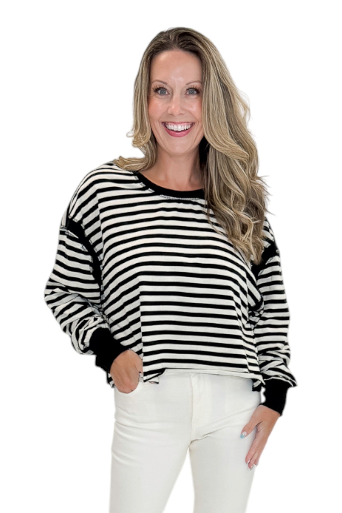 Front view of woman wearing Swagger Boutique’s Black &amp; White Striped Cut Out Back Sweatshirt with jeans against white studio background.