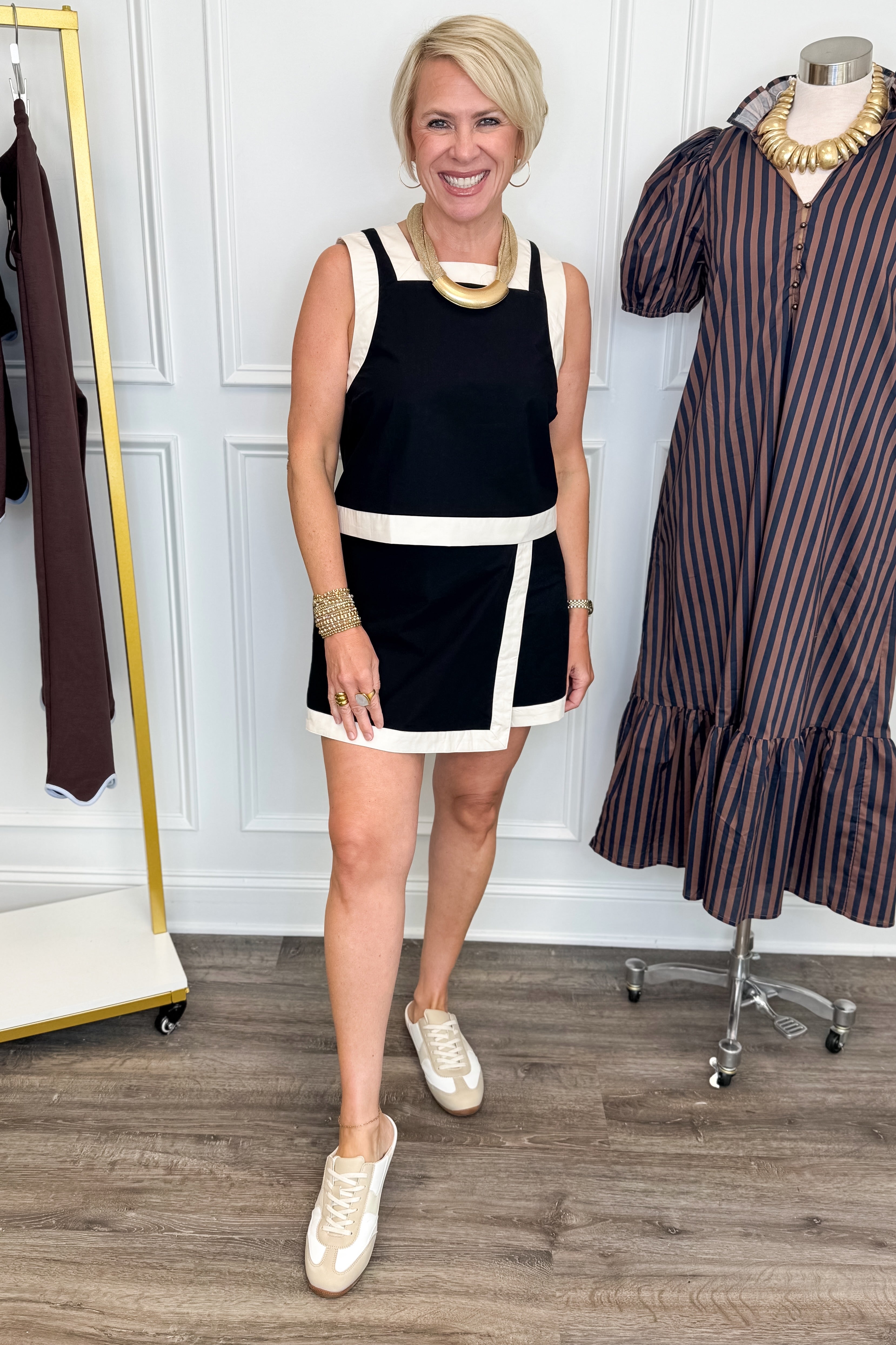 Front view of woman wearing Swagger Boutique’s Black &amp; White Wrap Skort &amp;  Square Neck Tank by Entro against white studio background. 