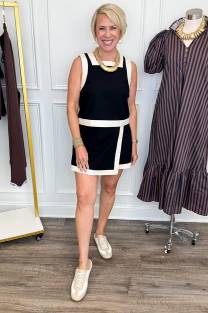Front view of woman wearing Swagger Boutique’s Black &amp; White Wrap Skort &amp;  Square Neck Tank by Entro against white studio background. 