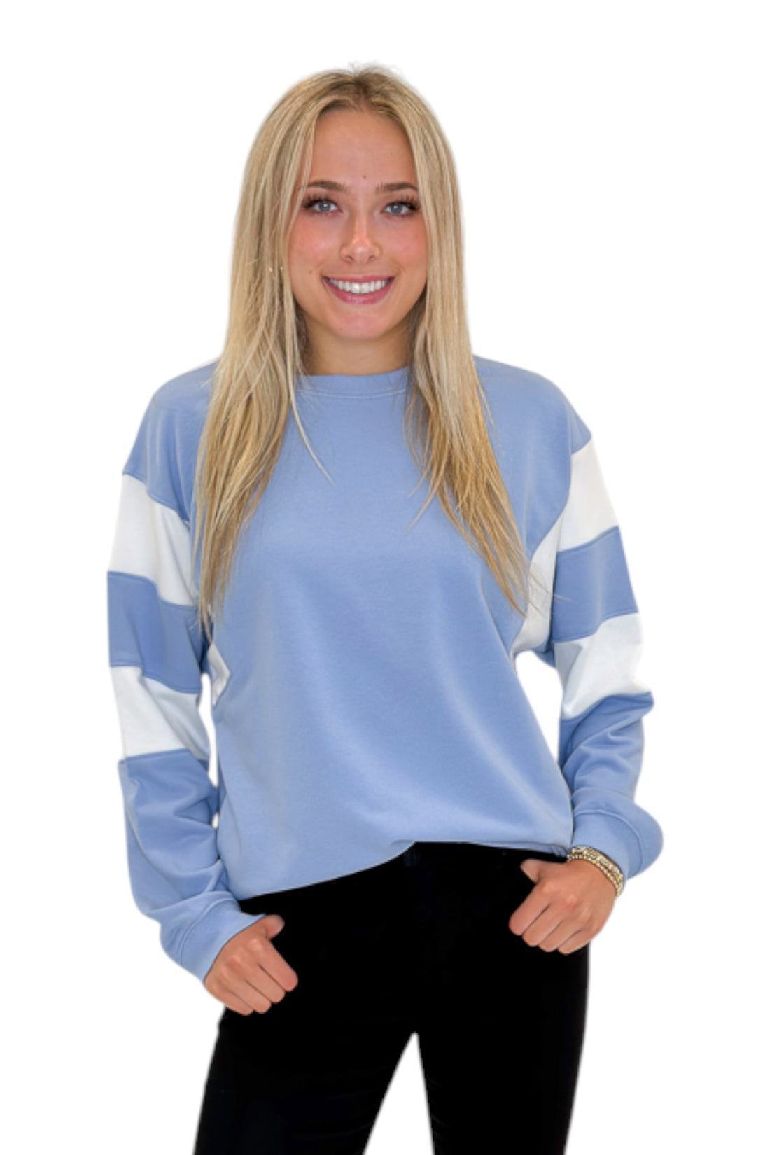 Front view of woman wearing Swagger Boutique’s Blue Color Blocked Long Sleeve Top with jeans against white studio background.
