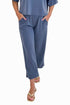 Front view of woman wearing Swagger Boutique’s Blue Cropped Lounge Pants and matching Blue Round Neck Short Sleeve Top against white studio background.