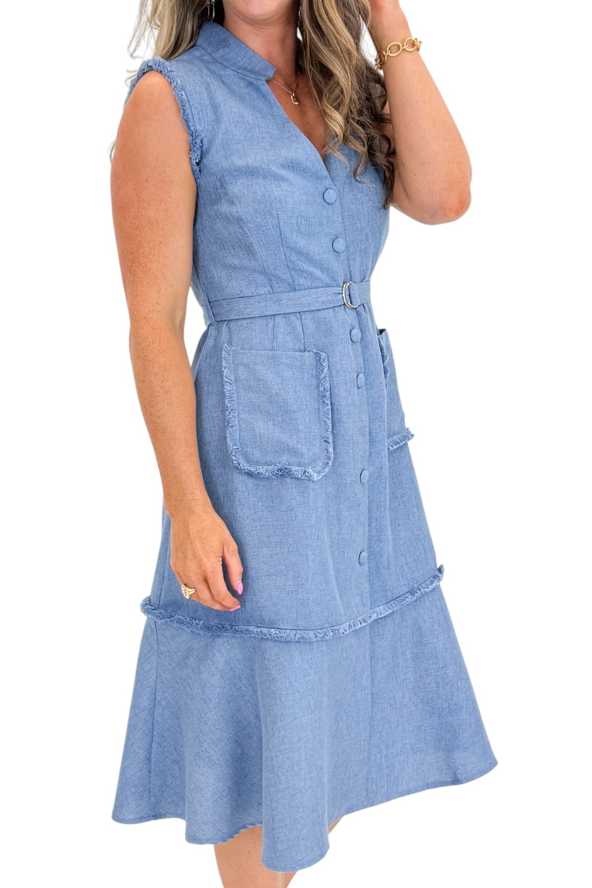 Side detail view of woman wearing Swagger Boutique’s Blue Fringe Sleeveless Midi Dress with sandals against white studio background.