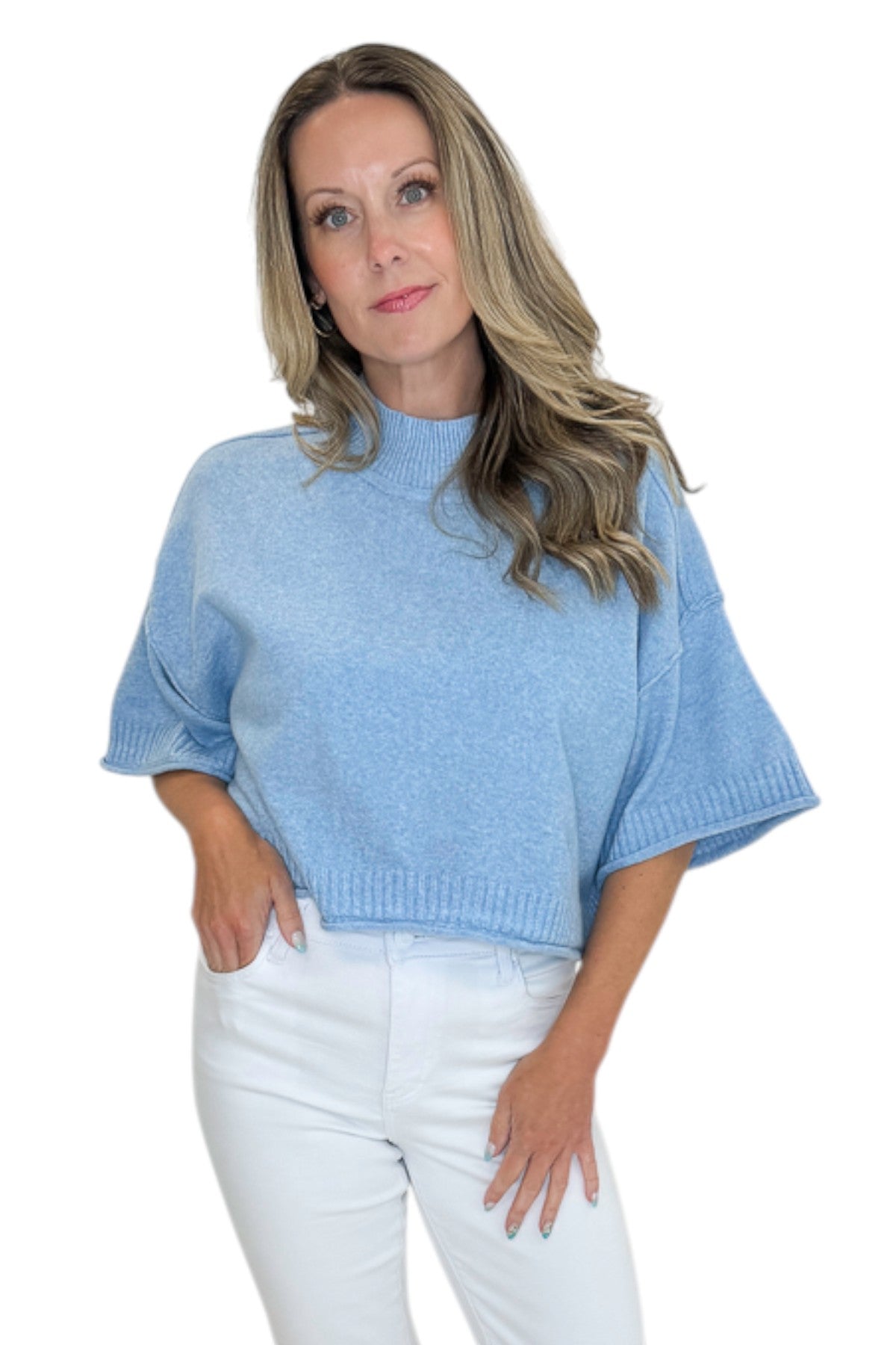 Front view of woman wearing Swagger Boutique’s Blue Ribbed Detail Short Sleeve Sweater with jeans against white studio background.