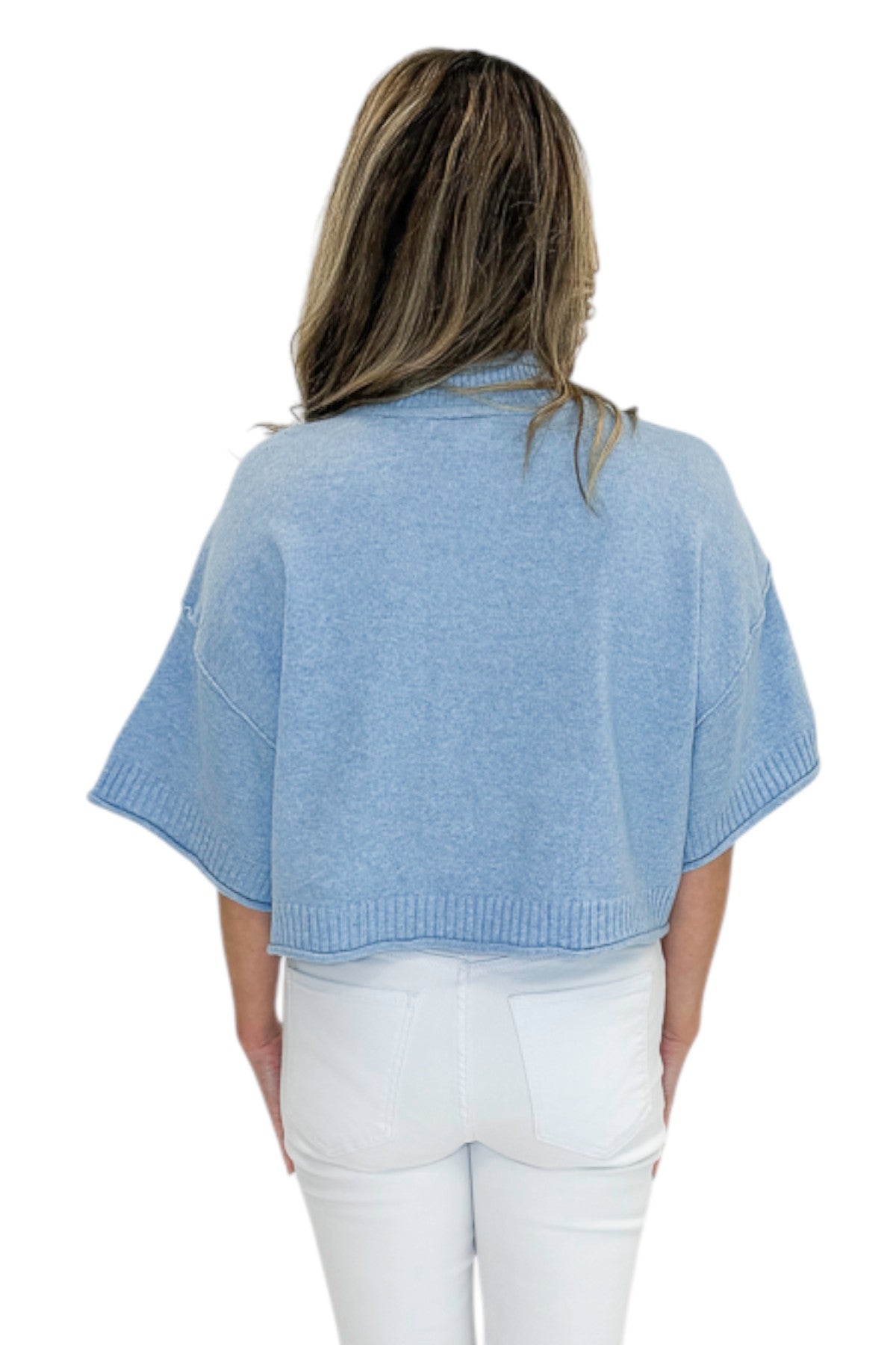 Back view of woman wearing Swagger Boutique’s Blue Ribbed Detail Short Sleeve Sweater with jeans against white studio background.
