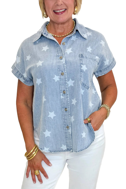 Front view of woman wearing Swagger Boutique’s Spark After Dark Blue Star Print Denim Top with jeans against white studio background.