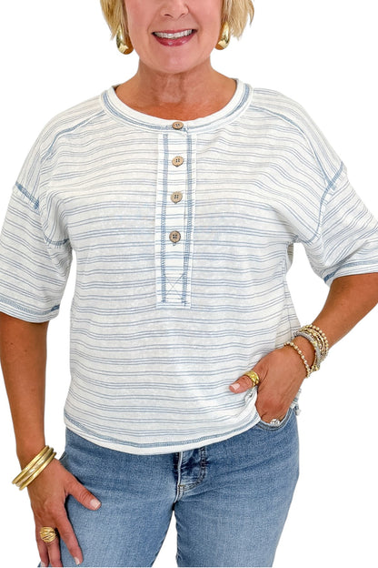 Front detail view of woman wearing Swagger Boutique’s Blue Striped Relaxed Fit Top with jeans against white studio background.