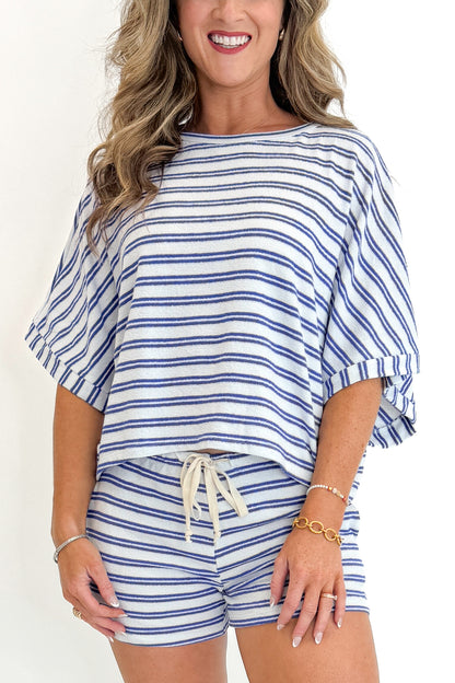 Front view of woman wearing Swagger Boutique’s Blue Striped Terry Cloth Shorts with matching Blue Striped Terry Cloth Top against white studio background.