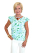 Front view of woman wearing Swagger Boutique’s Blue Tile Print Lydia Top by Mary Square with jeans against white studio background.