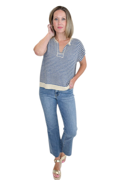 Front view of woman wearing Swagger Boutique’s Blue &amp; Beige Striped Sleeveless Sweater with jeans against white studio background.