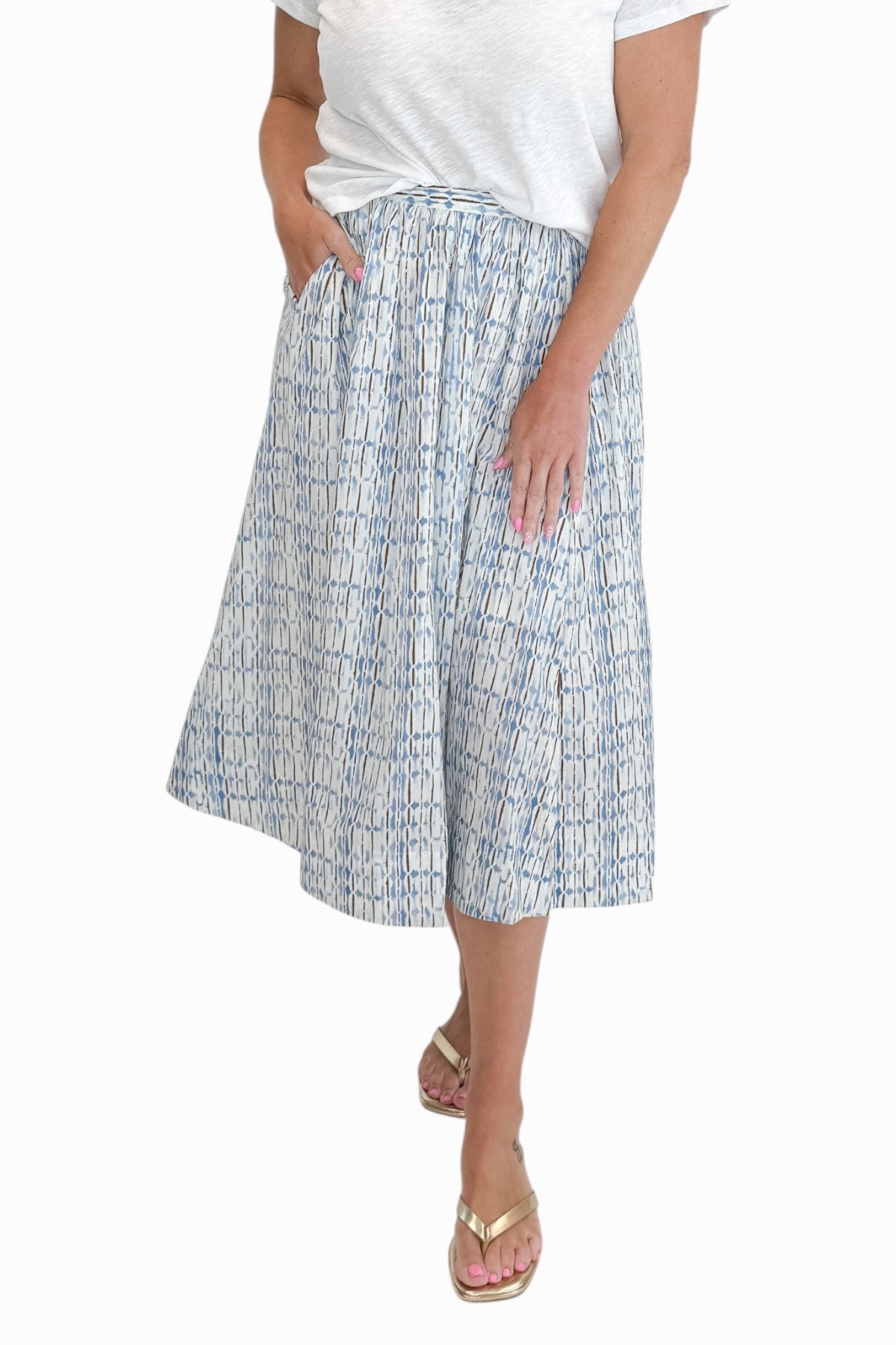 Front view of woman wearing Swagger Boutique’s Blue &amp; Brown Abstract Print  skirt against white studio background.