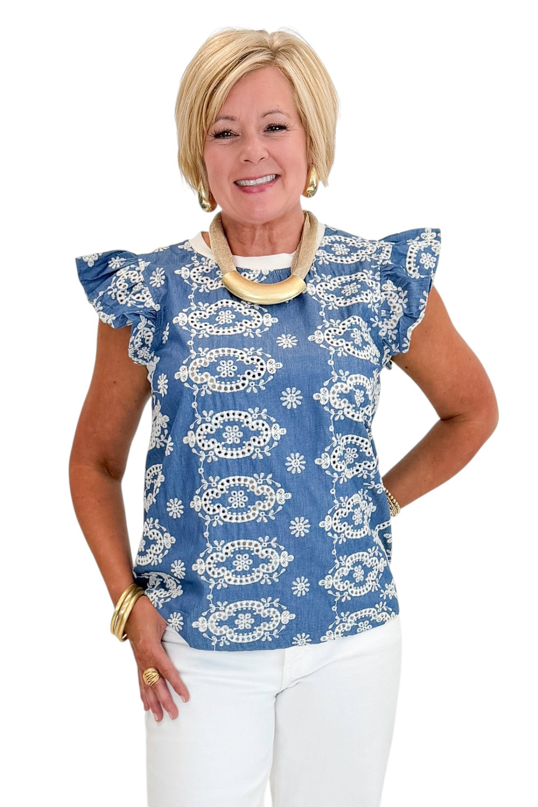 Front view of woman wearing Swagger Boutique’s Blue &amp; Cream Embroidered Top with jeans against white studio background.