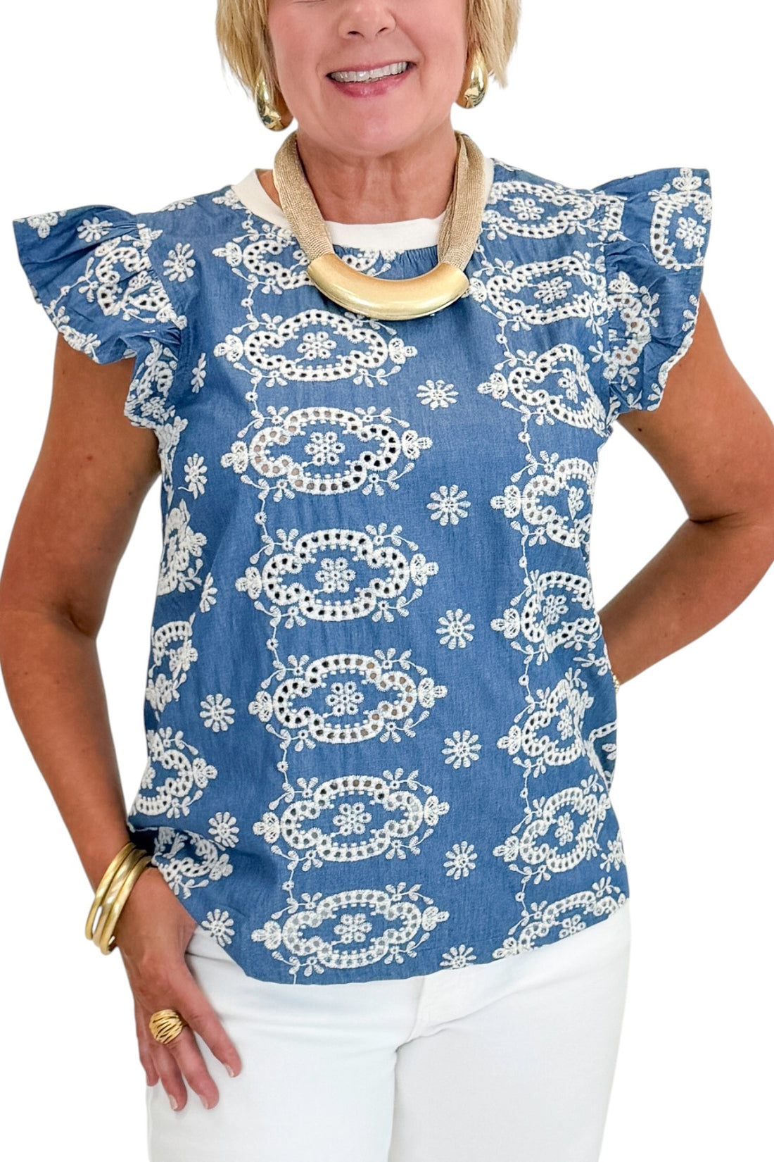 Front detail view of woman wearing Swagger Boutique’s Blue &amp; Cream Embroidered Top with jeans against white studio background.