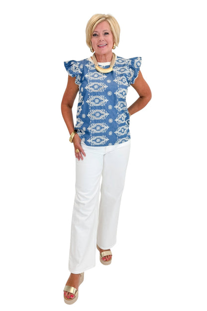Front view of woman wearing Swagger Boutique’s Blue &amp; Cream Embroidered Top with jeans against white studio background.