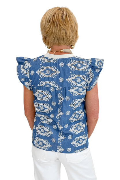 Back view of woman wearing Swagger Boutique’s Blue &amp; Cream Embroidered Top with jeans against white studio background.