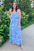 Front view of woman wearing Swagger Boutique’s Blue & Cream Animal Print Maxi Dress by Entro with sandals standing outside by flowers.