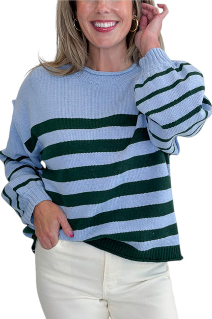 Front detail view of woman wearing Swagger Boutique’s Blue &amp; Green Striped Sweater with jeans against white studio background.
