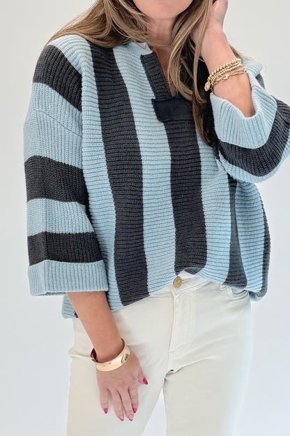 Front detail view of woman wearing Swagger Boutique’s Blue &amp; Grey Striped 3/4 Sleeve Sweater with jeans against white studio background.